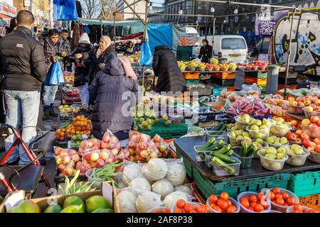 Whitechapel Market, outdoor daily fruit  and vegetable market stall, people food  shopping, Mile End Road,East End of London, UK Stock Photo