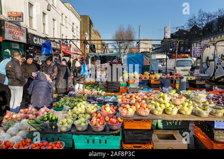 Whitechapel Market, outdoor daily fruit  and vegetable market stall, people food  shopping, Mile End Road,East End of London, UK Stock Photo