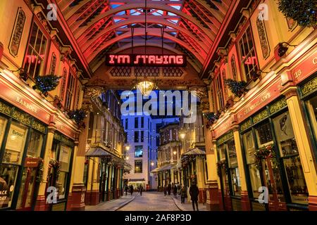 Leadenhall Market at Christmas, with 'I'm Staying' neon sign sculpture by Shaun C Badham, Sculpture in the City, London, UK Stock Photo
