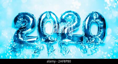 Balloon Bunting for celebration of New Year 2020 made from Silver Number Balloons. Holiday Party Decoration or postcard concept with top view and copy space. Banner size, toned in blue Stock Photo