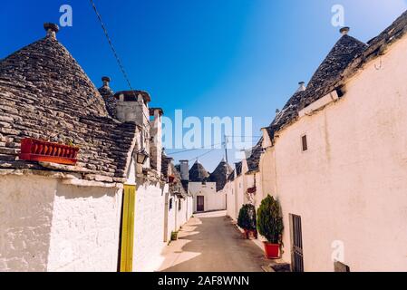 Stone tiles cover the roofs of the trulli in Alberobello, an Italian city to visit on a trip to Italy. Stock Photo