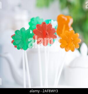 set of colored lollipops on the background of a tea service Stock Photo