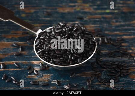 Black Forbidden Heirloom Rice Spilled from a Teaspoon Stock Photo - Alamy