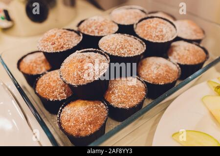 Many banana muffins. stack of banana muffins on a black plate closeup. Banana Cupcake Delicious Homemade on wood tray Freshly baked, sugary muffins. d Stock Photo