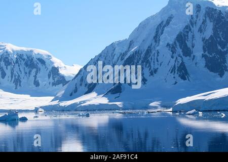 Mountains and icebergs between the islands around the Antarctic Peninsula, Palmer Archipelago, Antarctica Stock Photo