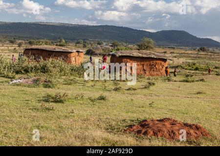 Tanzania.   Two Houses in Maasai Village of Ololosokwan, Northern Serengeti. Stock Photo