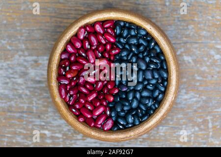 A bowl full of red beans and black beans separated. Stock Photo