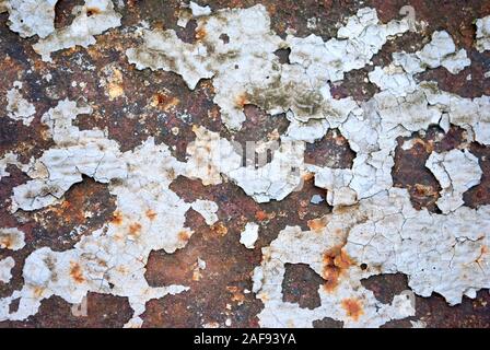 Textured industrial grunge background - old white peeling paint on the rough rusty surface Stock Photo