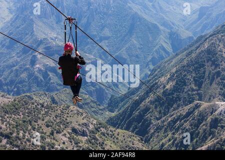 Ziplining at Divisadero, Copper Canyon, Chihuahua, Mexico.  8350 feet long, longest zip line in the world.  Speed may reach 70 mph on the descent. Stock Photo