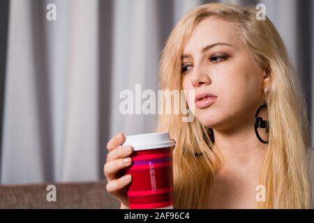 Bored depressed millennial girl drinking bad hotel coffee Stock Photo