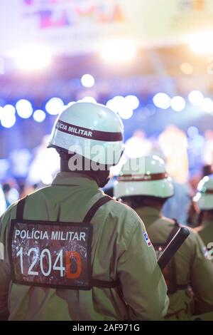 Brazilian police (State Police Militia - Policia Militar) on duty and wearing rio gear, defocused background, Salvador, Bahia Stock Photo