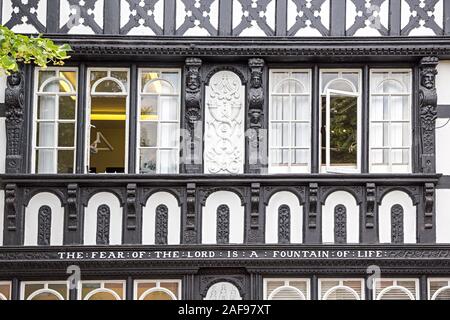 Timbered black and white building with religious inscription, the fear of the lord is a fountain of life, Chester, Cheshire, England, UK Stock Photo