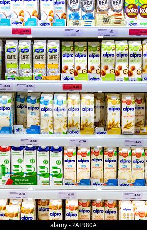 A selection of plant based and nut non-dairy milks at the supermarket, London, UK Stock Photo