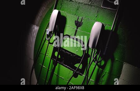 Electric vehicle charging station, free parking place green colored painted on wall symbol close up, no people Stock Photo