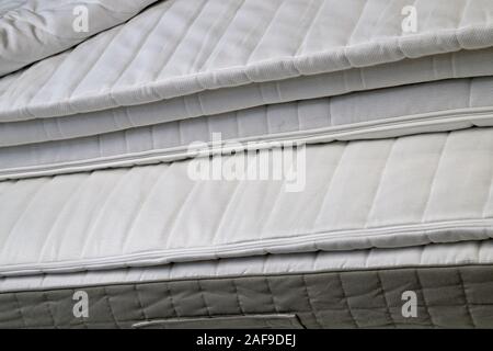 Folded white new bed mattresses filmed close-up Stock Photo