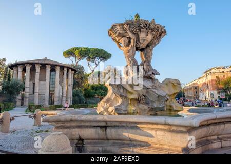 Rome fountains, Fontana dei Tritoni, Fountain of the Tritons, Piazza Bocca della Verita, with Temple of Hercules Victor in the background, Rome, Italy Stock Photo