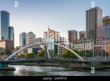 Melbourne, Australia - November 17, 2009: Evan Walker pedestrian bridge over Yarra River downtown with office highrise buildings in back under evening Stock Photo