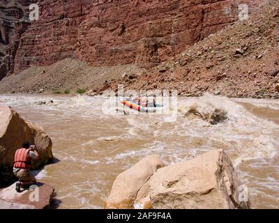 A 33' S-rig raft navigates through the Big Drop II rapid in Cataract Canyon on the Colorado River in Canyonlands National Park in Utah.  Flow level wa Stock Photo