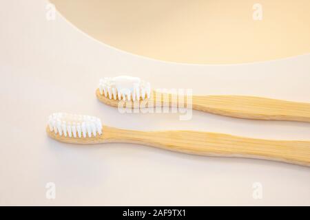 Two bamboo toothbrushes on a bathroom counter Stock Photo