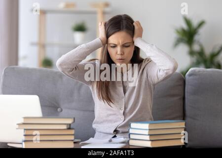Upset girl student worried making mistake studying Stock Photo
