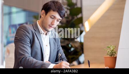 Asian businessman sign or write document in modern office Stock Photo