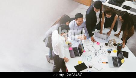 Group of Asian business people team meeting in modern office working design planning and ideas concept Stock Photo