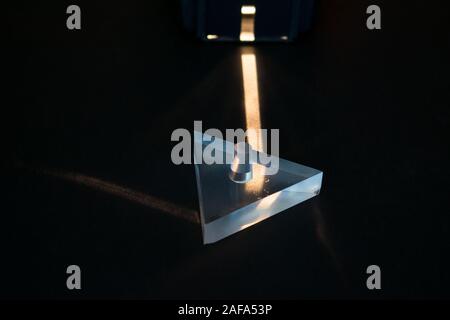 Physics experiment. Demonstration of reflection of light in a prism. Stock Photo