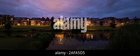 Panoramic view of modern houses in traditional dutch style along a canal in Holland Stock Photo