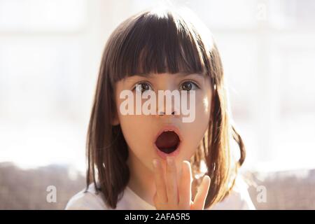 Head shot portrait of shocked little girl with open mouth Stock Photo