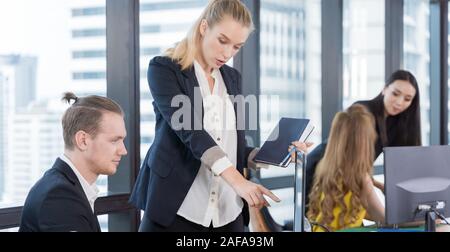 Business people on suit are meeting in office city building view. Group of Business team working and share ideas about project to partners Stock Photo