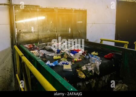 Recycling. Sorting garbage on a conveyor belt. The technological process at the waste recycling plant. Processing and storage of waste for further dis Stock Photo