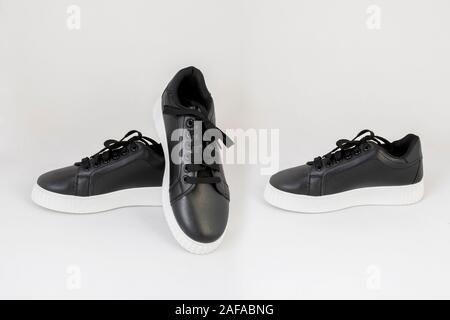 black leather sneakers shoes isolated on white background side and front view Stock Photo