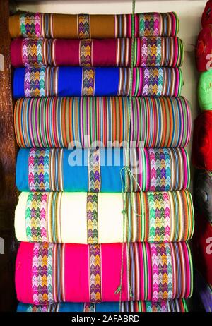 Peruvian traditional colourful native handicraft textile fabric at market in Machu Picchu, one of the New Seven Wonder of The World, Cusco Region Peru Stock Photo