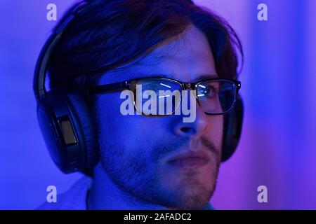 Hacking concept. Man in glasses looking at computer screen Stock Photo