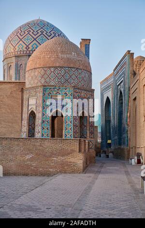 Shirin Biqa Aqa or Octagonal Mausoleum and narrow path through facades heavily decorated with blue tiles in necropolis Shah-i-Zinda, Samarqand, Uzbeki