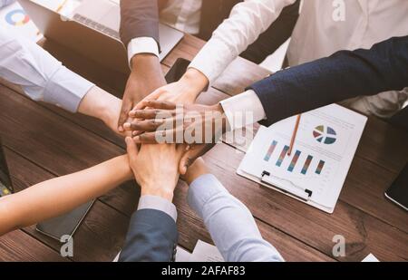 Top view on diverse corporate team hands stacked together Stock Photo