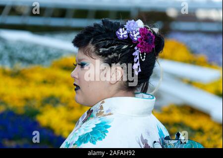 Beautiful Japanese teenager wearing traditional kimono looking sideways with close-up on hair ornament celebrating the Coming of Age Day in Fuji City, Stock Photo