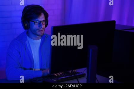Man in front of computer, using pc late in night Stock Photo