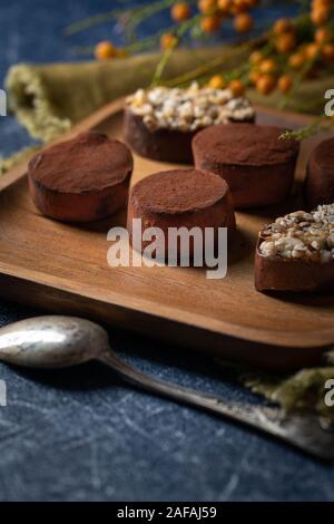 chocolate truffles on a wooden plate Stock Photo