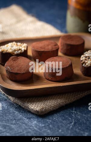 chocolate truffles on a wooden plate Stock Photo