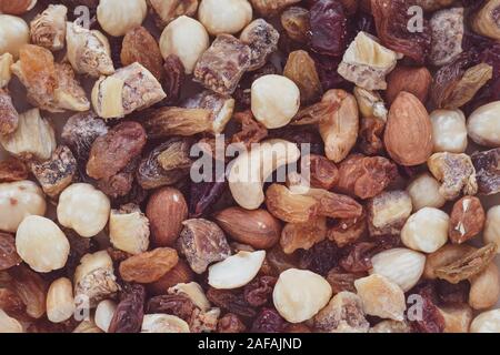 A bunch of dried fruits and nuts. Texture, background. Pile of raisins. Health food concept. Vegetarian diet Stock Photo