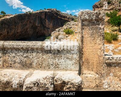 Inscription on Severan Bridge, Cendere Koprusu is a late Roman bridge, close to Nemrut Dagi and Adiyaman, Turkey. Roadway flanked by ancient columns Stock Photo