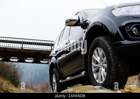 Big car wheel on towering on stones. Offroad 4x4 concept Stock Photo