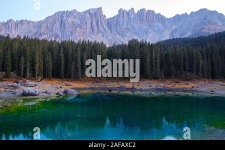 Beautiful Carezza Lake (Lago di Carezza) in background Latemar Mountains in Dolomites, Italy Stock Photo