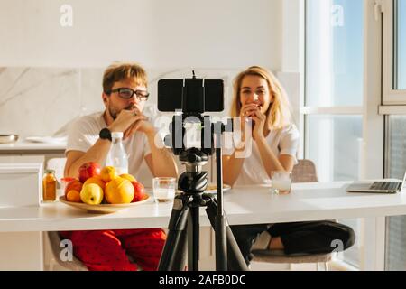 Young Couple Video Bloggers Streaming Live Video Using Camera Stock Photo