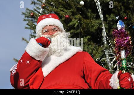 Cherkasy, Ukraine,December,30, 2012:   Santa Claus speak near the  fir-tree with  christmas decorations Stock Photo