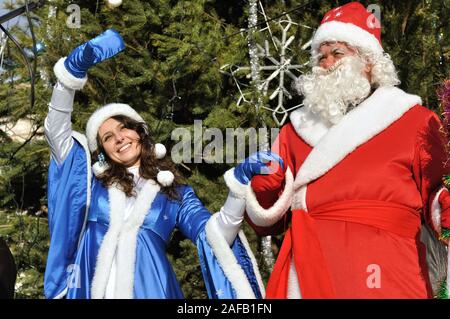 Cherkasy, Ukraine,December,30, 2012: Santa Claus with a snow maiden took part in New year show near the Christmas tree Stock Photo