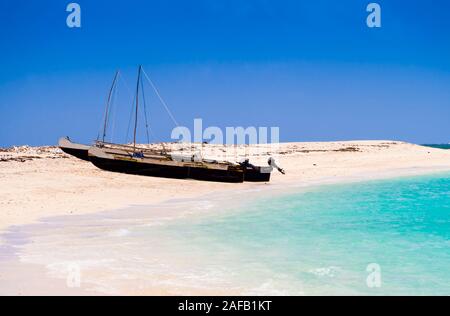Typical outrigger fishermen pirogues moored on turquoise sea of Nosy Ve island, Indian Ocean, Madagascar Stock Photo