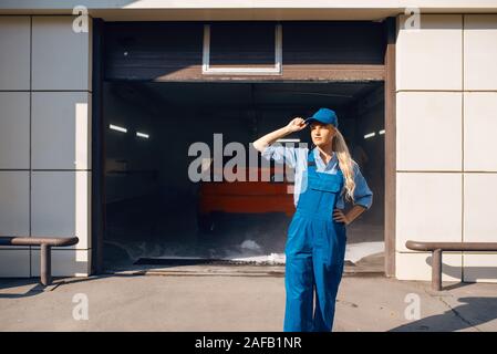 Pretty female washer in uniform, car wash Stock Photo