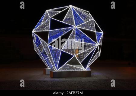 Beautiful big Christmas tree bauble as illuminated street seasonal decoration. Stock Photo